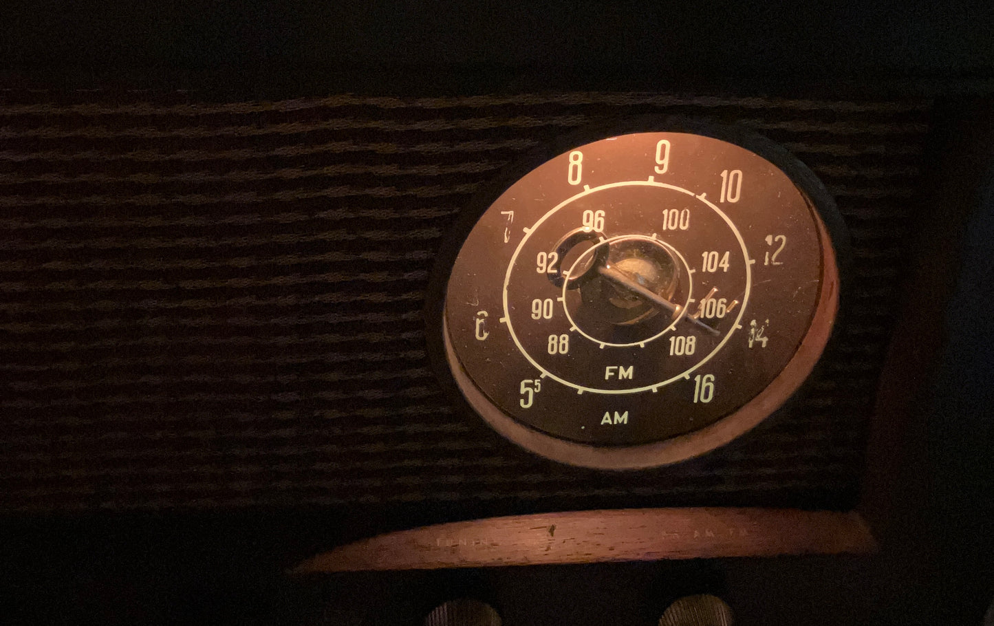 The lighted dial of an antique tube radio